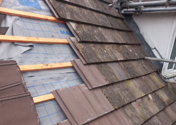 Professional roofing restoration by FRR Midlands showing the installation of modern breathable membrane, treated timber battens, and high-grade interlocking tiles on a residential property.