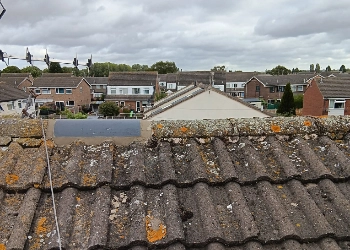 Close-up of a professional ridge tile repair on a residential tiled roof performed by FRR Midlands Ltd in a local housing estate.